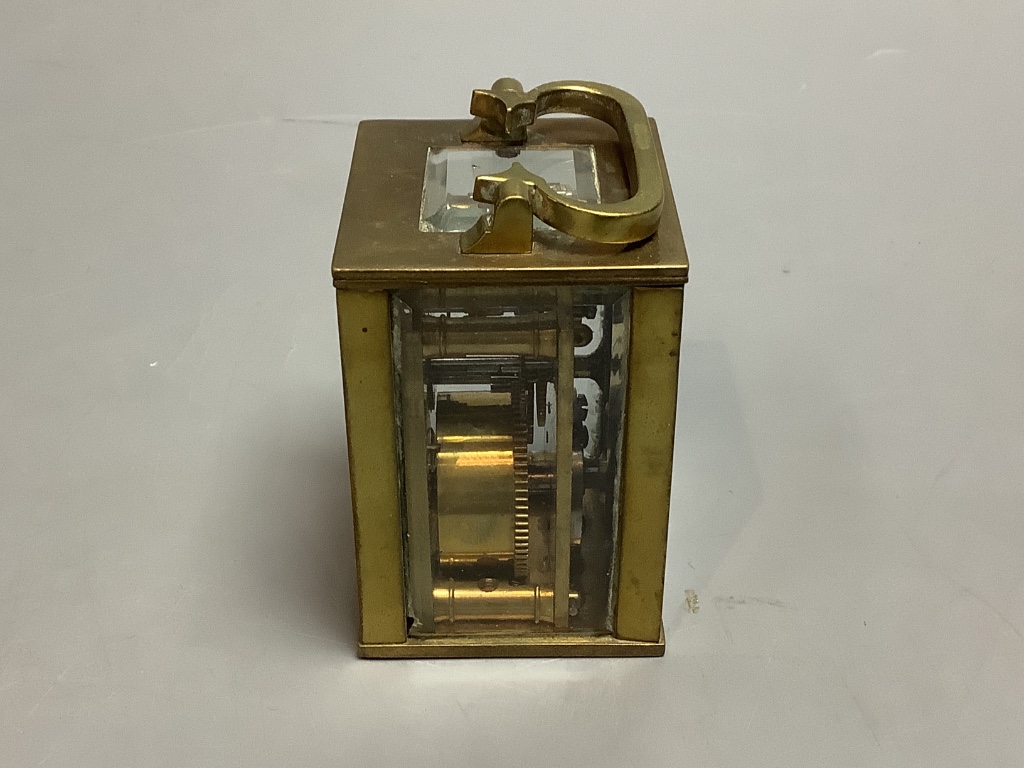 A brass cased miniature timepiece, height 6cm excluding handle.